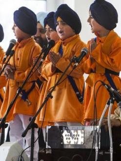 Five young Sikhs representing the first five initiated members of the Khalsa in 1699, sing during Vaisakhi celebrations at the Sikh Temple of Utah yesterday. (source: Deseret News)